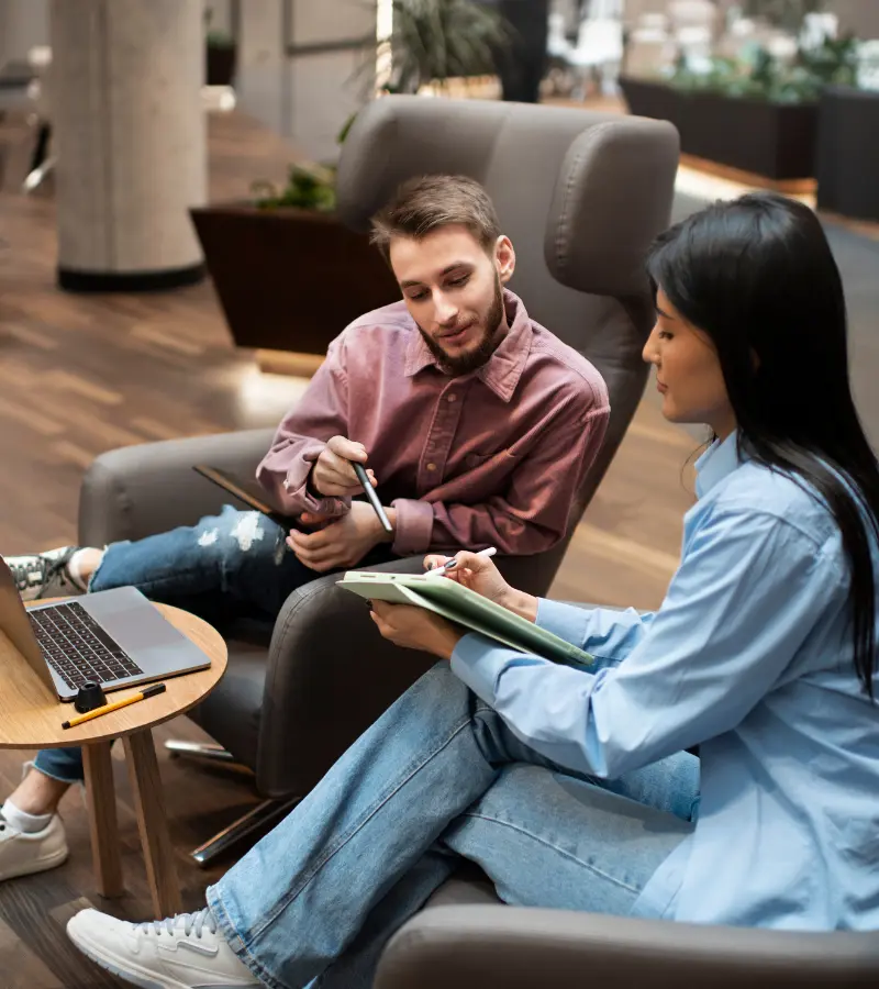 Two staff members discussing international relocation services.