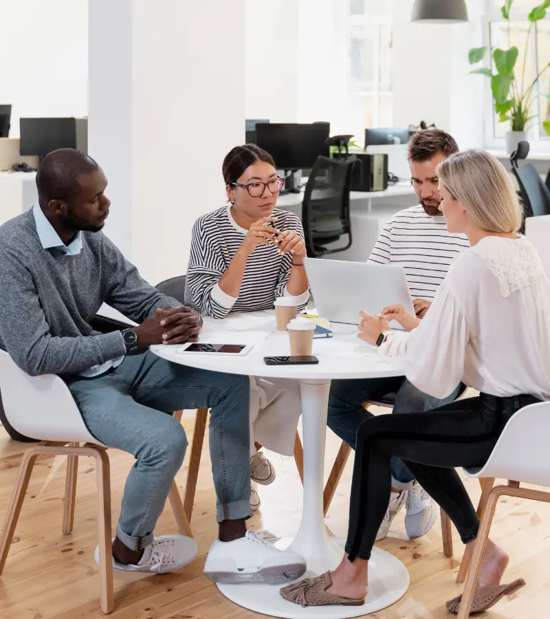 Coderwan team discussing project strategy during a meeting at a conference table